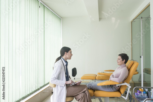 A Woman Physician Talking With Her Patient