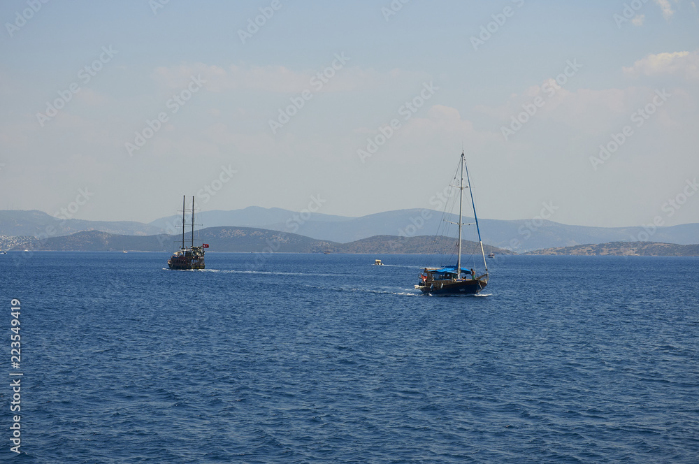 Water excursion in Turkey. Two ships diverge in the Sea. Blue sea and. Coast of the Aegean Sea. Turgutreis , Bodrum.mountains.
