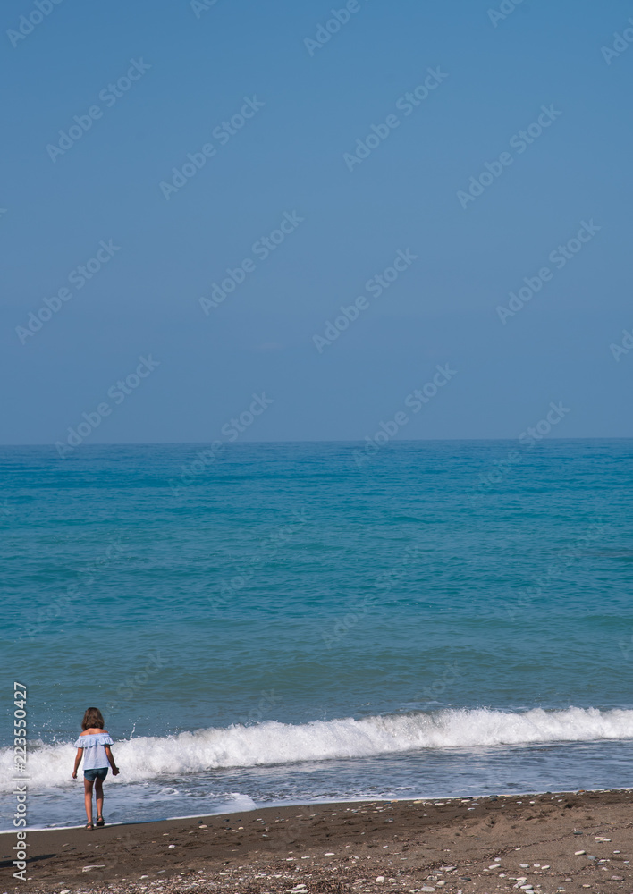 Young kid at the edge of the shore