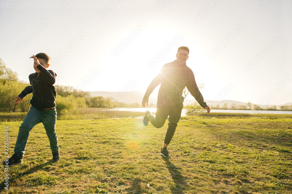 father and son play in nature