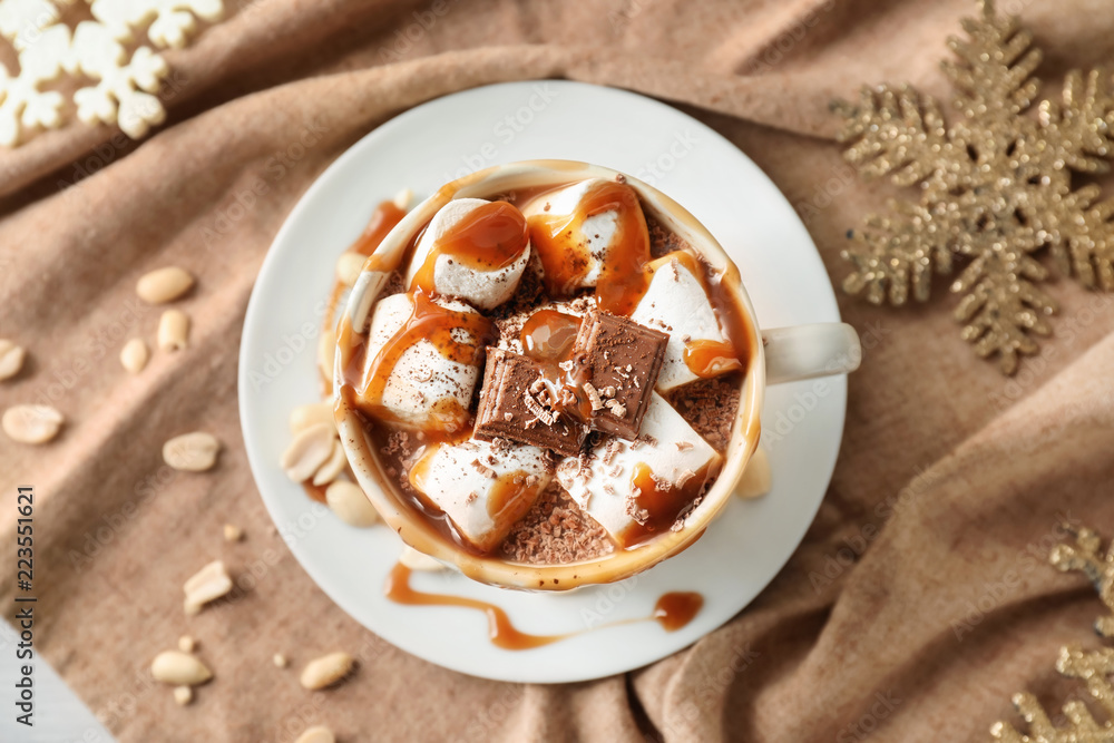 Cup of hot chocolate with marshmallows and caramel on napkin Cup of hot chocolate with marshmallows and caramel on napkin
