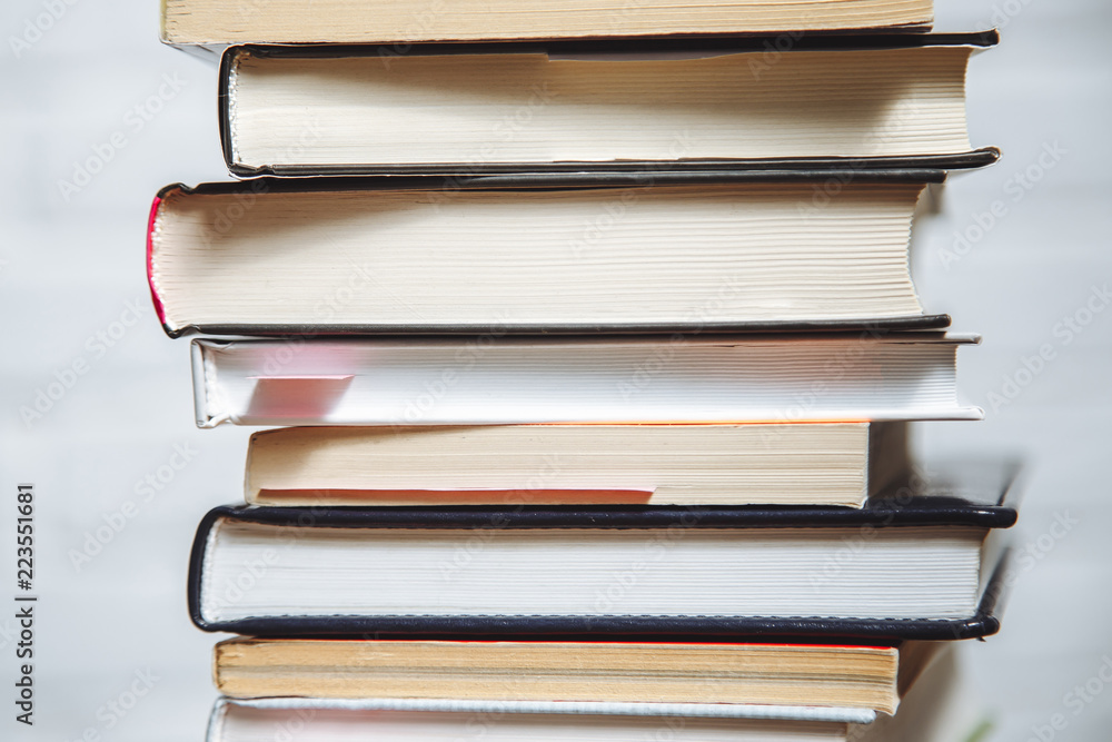 Stack of hardback books on wooden table. Back to school. Stack of hardback books on wooden table. Back to school.