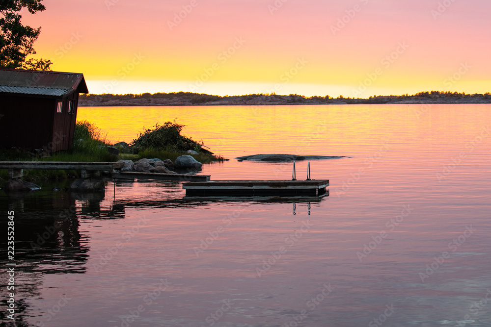 Fototapeta premium Looking past the swim float just before sunset on the Island of Aspö in Archipelago National Park (Skärgårdshavet nationalpark), Finland, 4 days after the summer solstice.