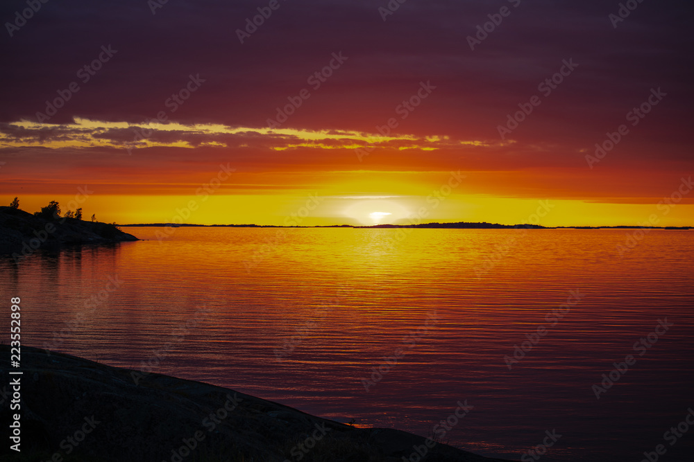 The setting sun on the Island of Aspö in Archipelago National Park (Skärgårdshavet nationalpark), Finland, 4 days after the summer solstice.
