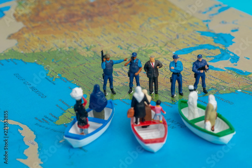 Miniature people concept of Middle Eastern people arrive by boat to the border of USA. © AHMAD FAIZAL YAHYA