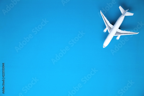 Airplane on blue background. Travel concept