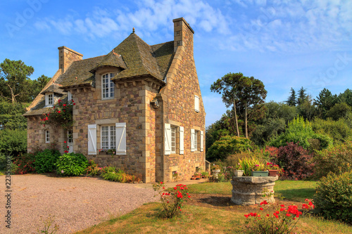 Beautiful view of a traditional French country house in Brittany, France, in summer with a blue sky