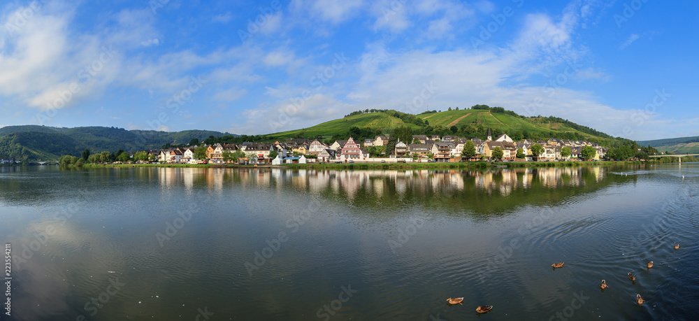 Beautiful 180 degree panoramic sunrise view of the river Moselle at the small wine growing town Zell (an der Mosel) on a summer morning