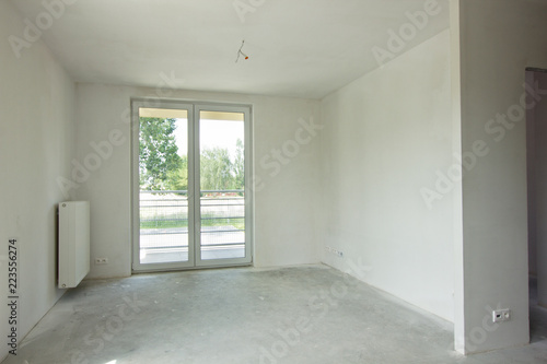 Empty unfinished ready for renovations room with window in a new constructed building