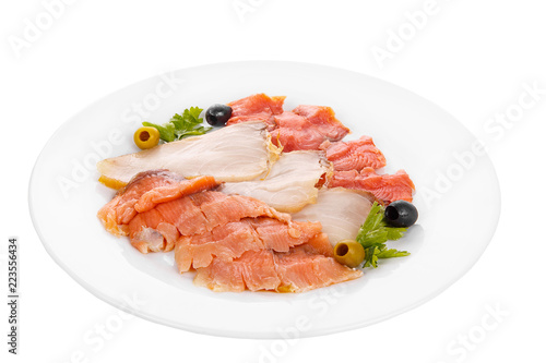 Cold appetizer before alcohol, assorted fish, salmon fillet, lightly salted, chum, smoked with wasabi sauce, mayonnaise, sour cream, olives, parsley on plate, white isolated background Side view