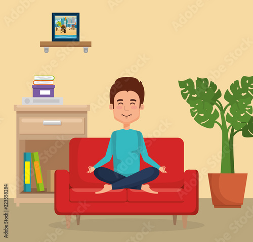 young man practicing yoga on the sofa