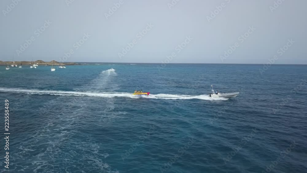 The riders are towed into the sea on a banana boat The riders are towed into the sea on a banana boat