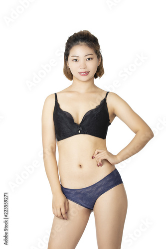 Chinese woman posing in panties and bra on white background