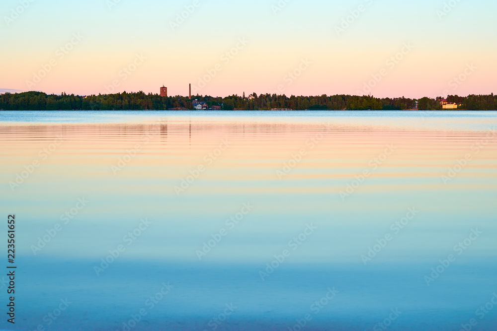Peaceful sunset on lake with pastel colors. Natural background. 