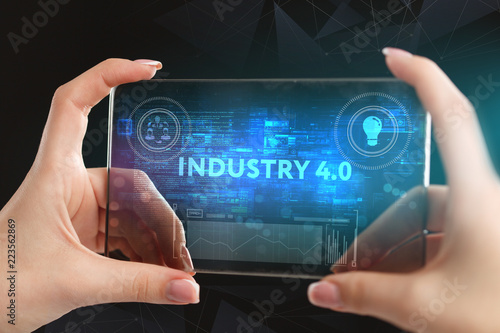 The concept of business, technology, the Internet and the network. A young entrepreneur working on a virtual screen of the future and sees the inscription: Industry 4.0