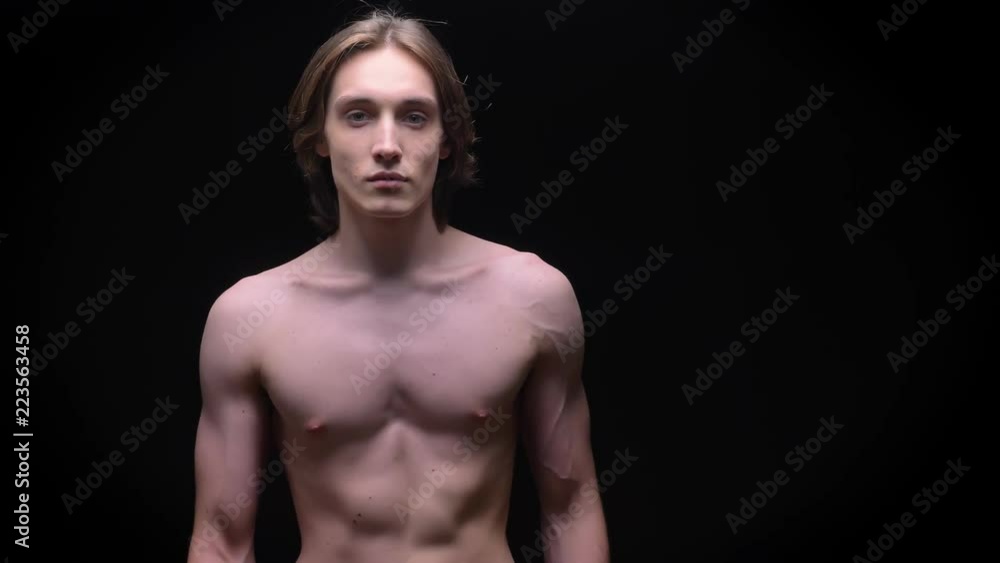 athletic caucasian boy stepping into camera and showing muscles on sporty body athletic caucasian boy stepping into camera and showing muscles on sporty body