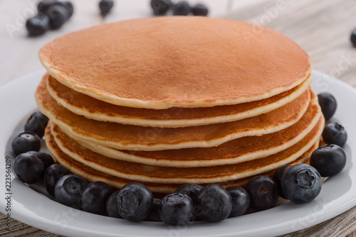 Blueberries and stacked thick pancakes