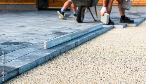 Obraz na płótnie Laying gray concrete paving slabs in house courtyard driveway patio