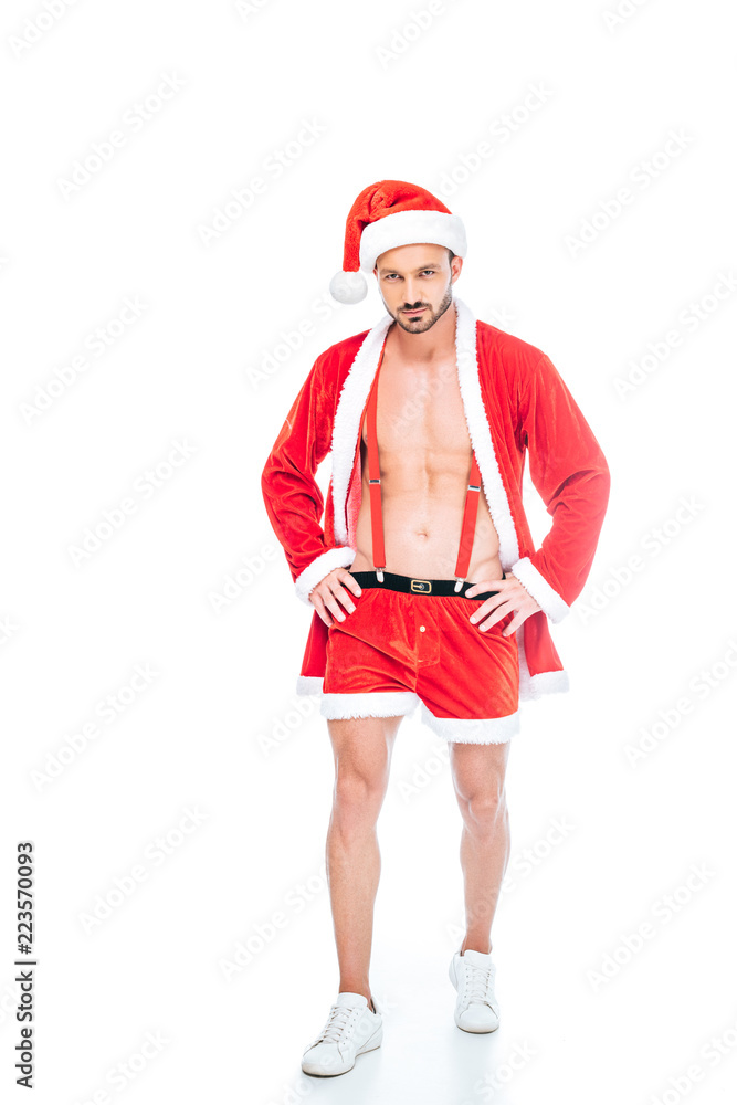 young muscular man in santa claus costume and shorts showing torso isolated on white background young muscular man in santa claus costume and shorts showing torso isolated on white background