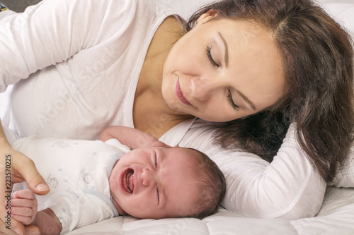 Mother calming her crying baby girl 