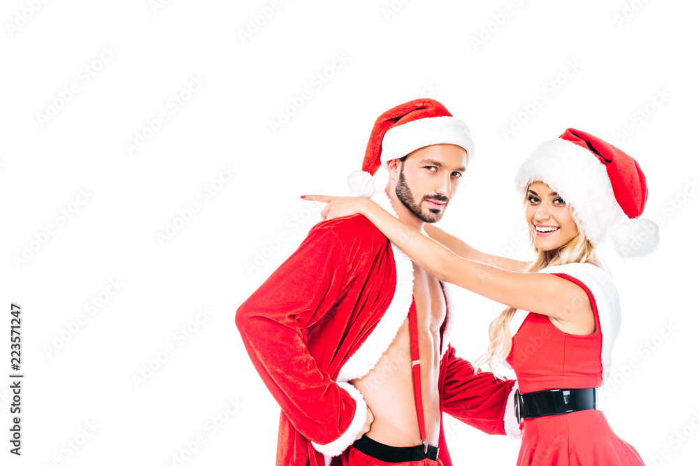 smiling young woman in christmas hat and dress embracing boyfriend isolated on white background smiling young woman in christmas hat and dress embracing boyfriend isolated on white background