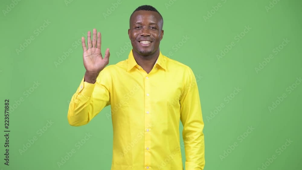 Young happy African businessman waving hand Young happy African businessman waving hand