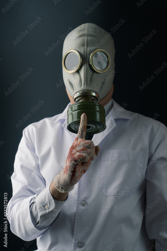 Evil and creepy medical experiment concept, a scary doctor in gas mask  making silence gesture on dark background Stock Photo | Adobe Stock