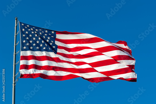 Wallpaper Mural An American flag flying in the breeze against a cloudless bright blue sky. Torontodigital.ca