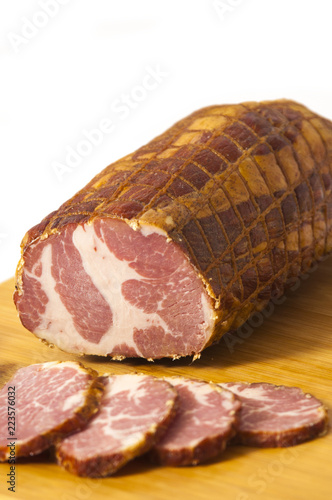 Hickory smoked sliced pork shoulder stuffed in a net isolated on white background - Dimljeni suvi vrat