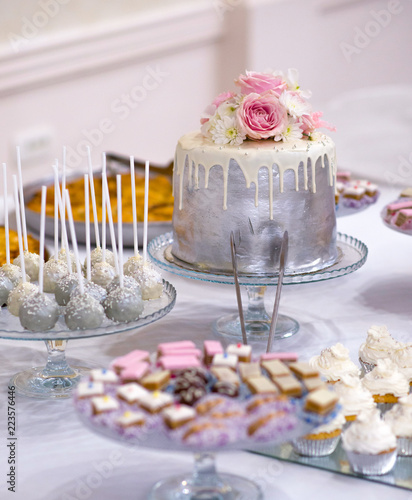 wedding cake and various sweet food on a table