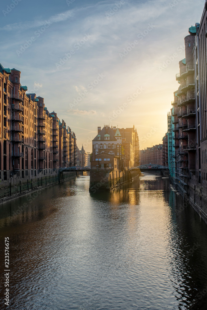 famous historic warehouse district Speicherstadt in Hamburg, Germany in golden sunlight