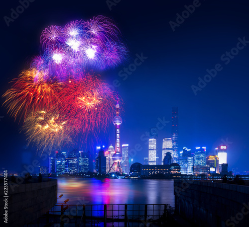 Shanghai city celebrate night with celebration freworks and light from modern city skyscrapers and reflection of beautiful ligth in Huangpu river, Shanghai, China in China nation day photo