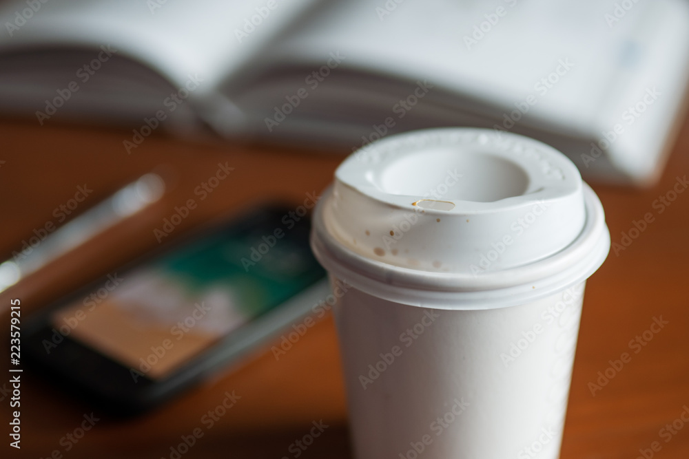 Paper coffee cup on table