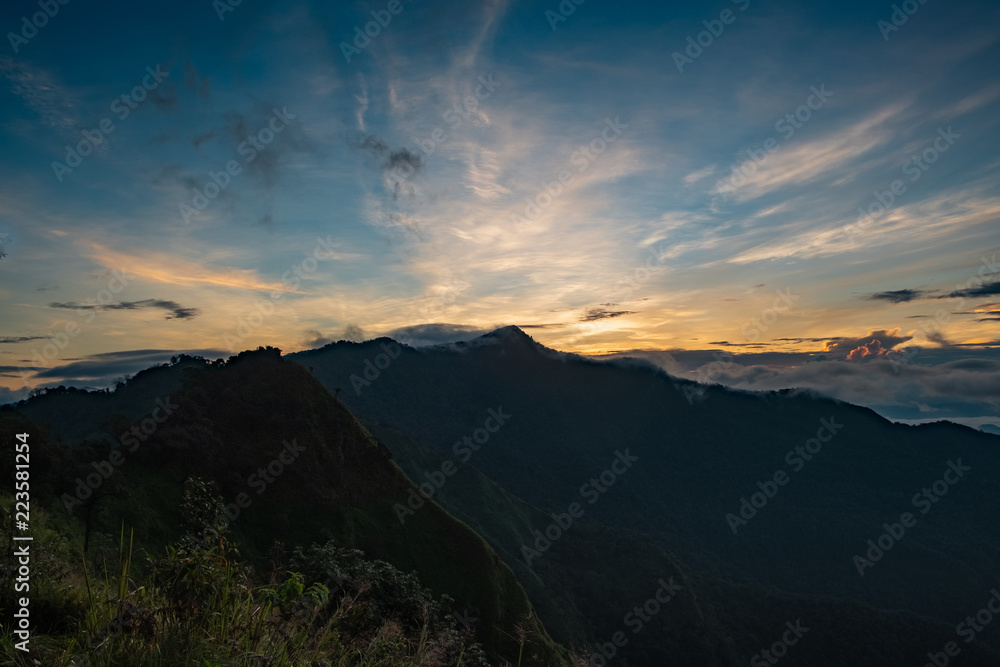 View of nature. The top of the mountain, the sun, the mist and the mountain. at Doi Phu Kha, Nan. Low light and noise.