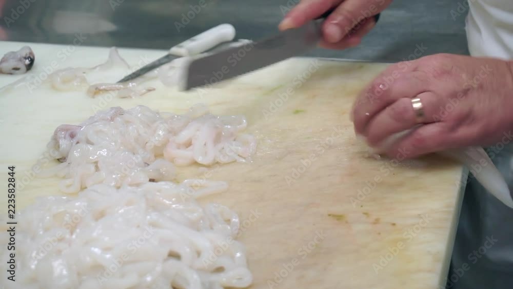 Squids cut into rings by the cook in the restaurant Squids cut into rings by the cook in the restaurant