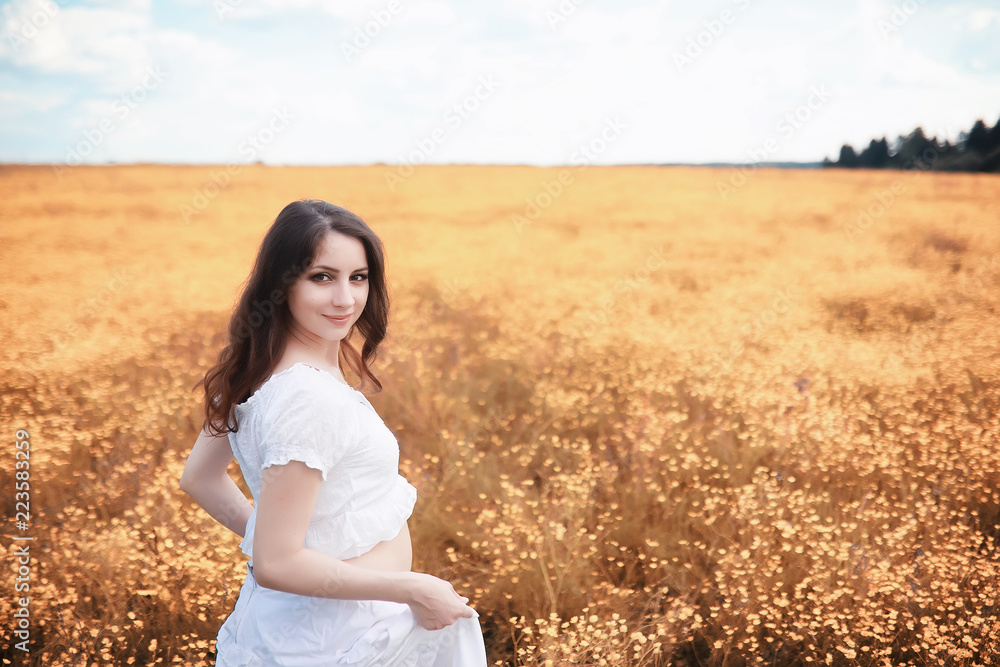 Pregnant woman in nature for a walk in the autumn Pregnant woman in nature for a walk in the autumn