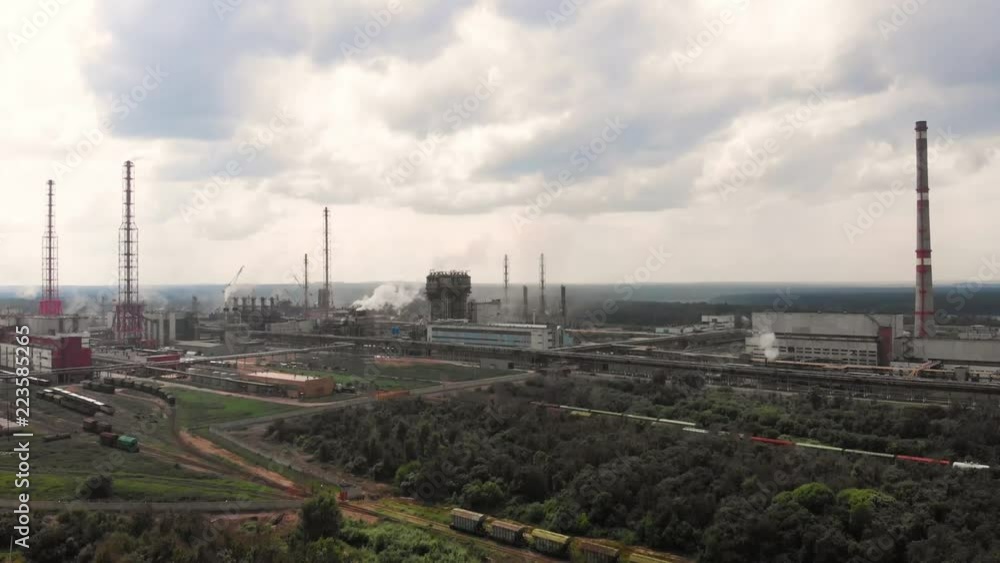 flight of the camera over the Oil refinery plant industry, Refinery factory, oil storage tank and pipeline steel with sunrise and cloudy sky background, Russia.