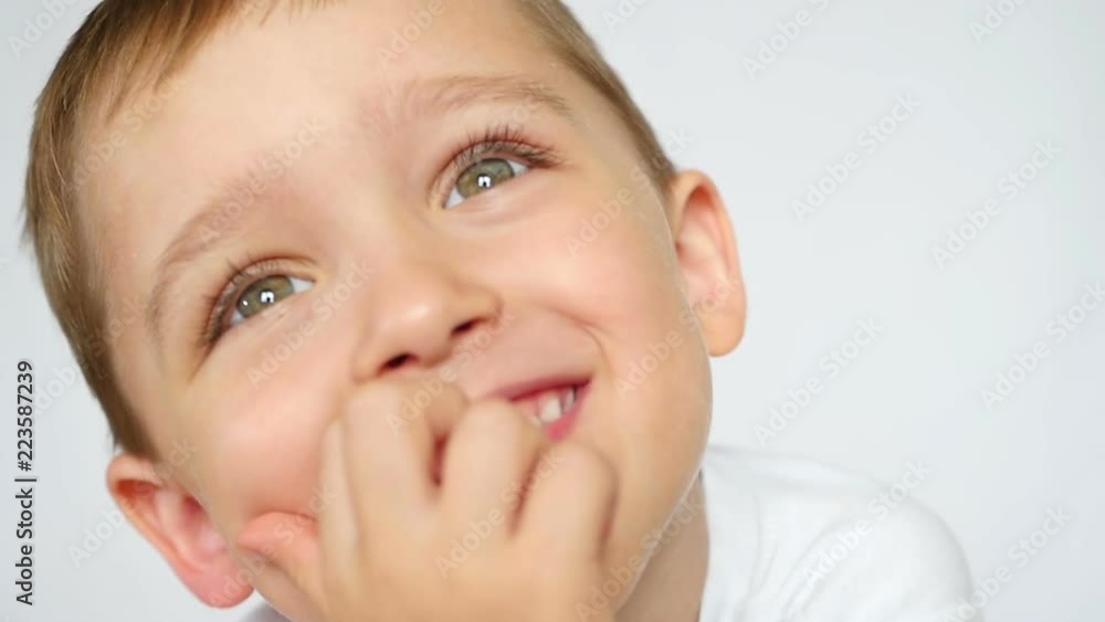 Joyful child smiles and closes his mouth close up. Joyful child smiles and closes his mouth close up.