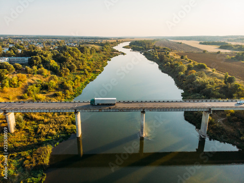 Aerial view of bridge over Don river in Voronezh, autumn landscape from above view with highway road and car transportation