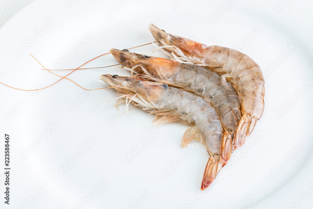 Close-up of fresh, raw and whole prawns. On white background. Close-up of fresh, raw and whole prawns. On white background.