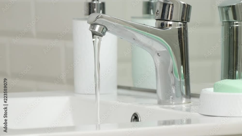 Interior Bathroom Image With Water Flowing in the Sink