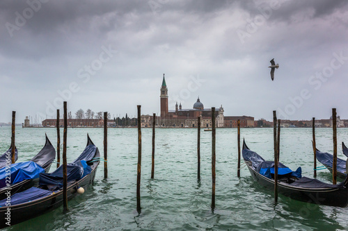 San Giorgio Maggiore church and gondolas at cloudy day in Venice, Italy. © Mazur Travel