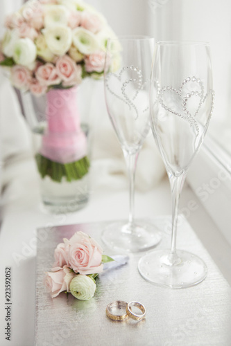 Wedding rings with flowers and glasses