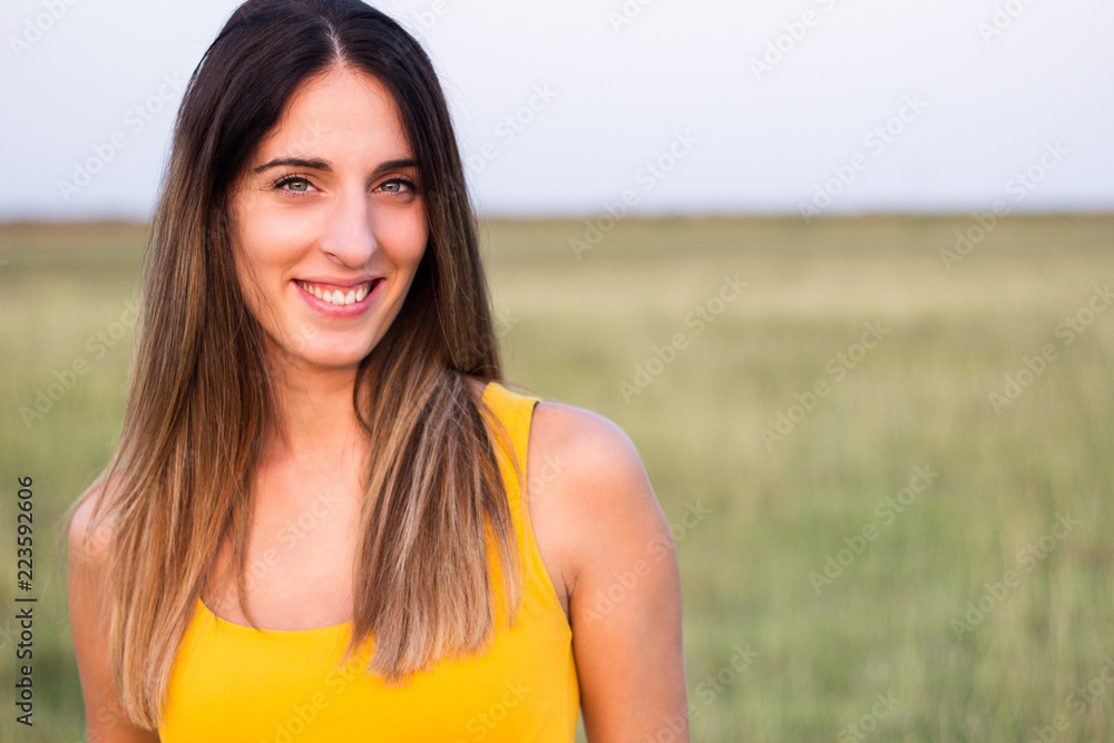 Portrait of beautiful woman in meadow Portrait of beautiful woman in meadow