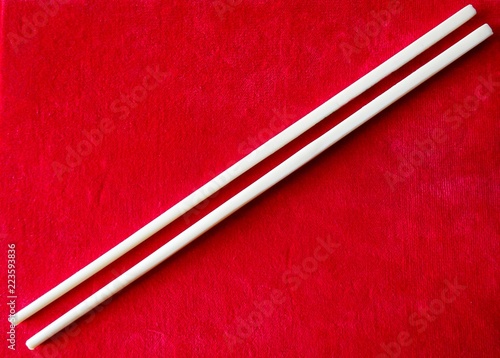 Chinese Sticks Chopsticks For Asian Food Eating On The Red Textile Velvet Cloth Background 