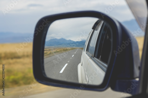 Reflection of the road at the car side mirror.