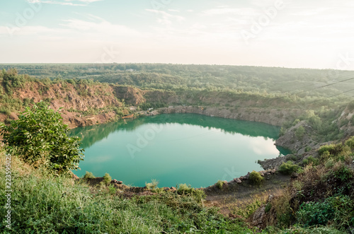 Radon quarry with green water in the sunset