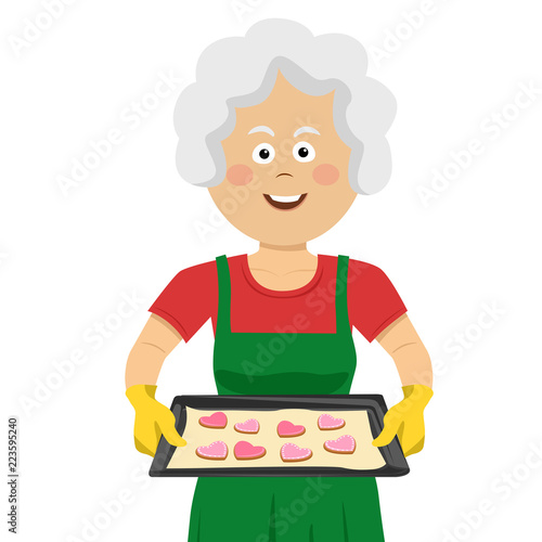 Mature lady holding a tray with homemade cookies isolated on white background