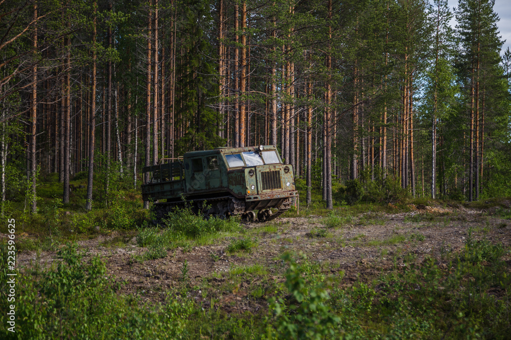 Old soviet artillery tractor by the woods