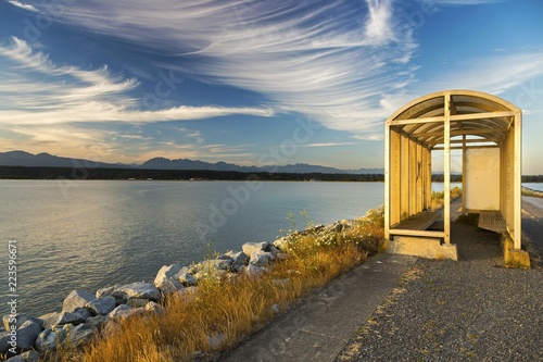 Fototapet Wind Storm Shelter on Walking Path on Iona Jetty Pier with distant view of UBC,